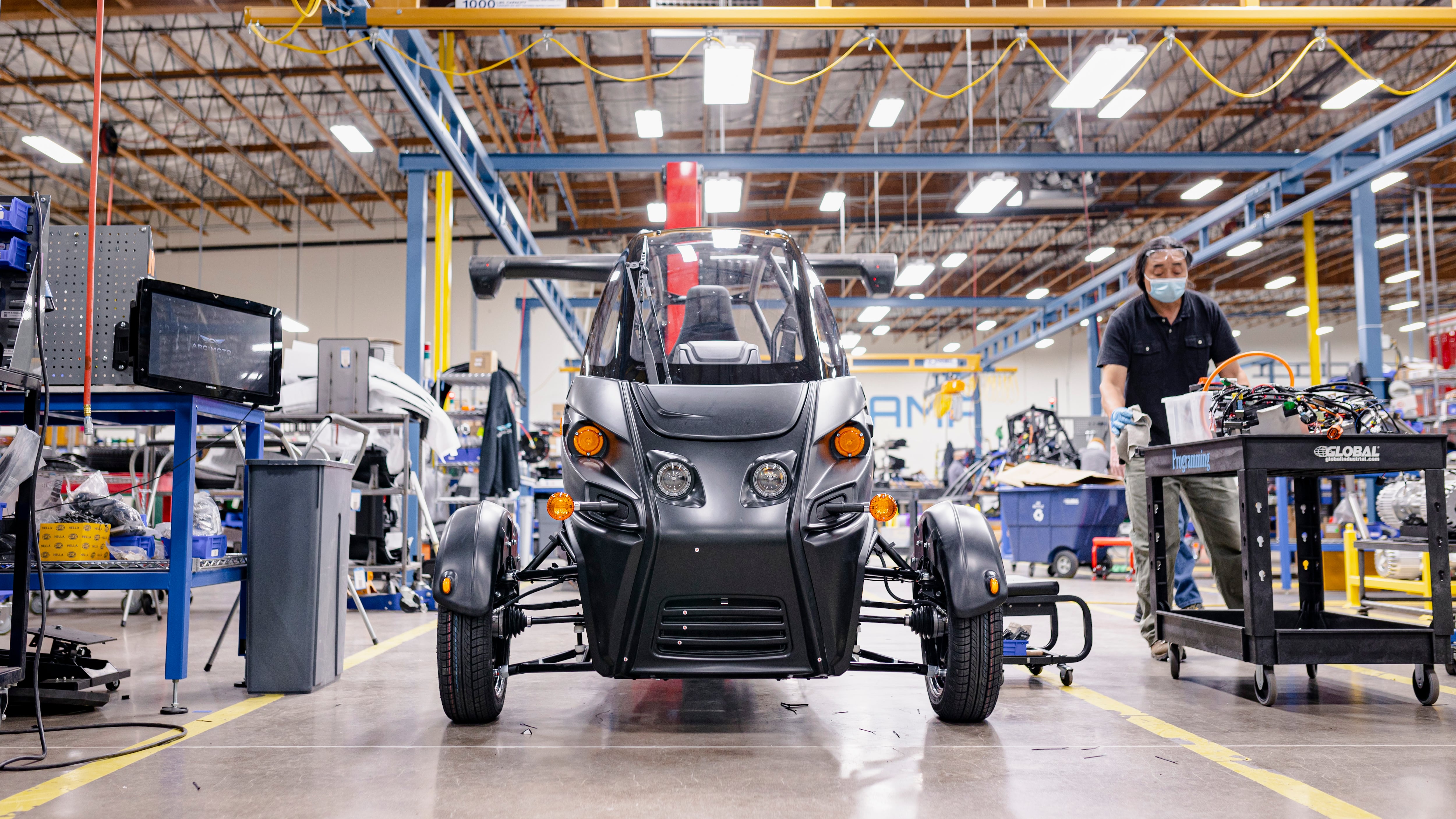 Worker assembling an electric vehicle.