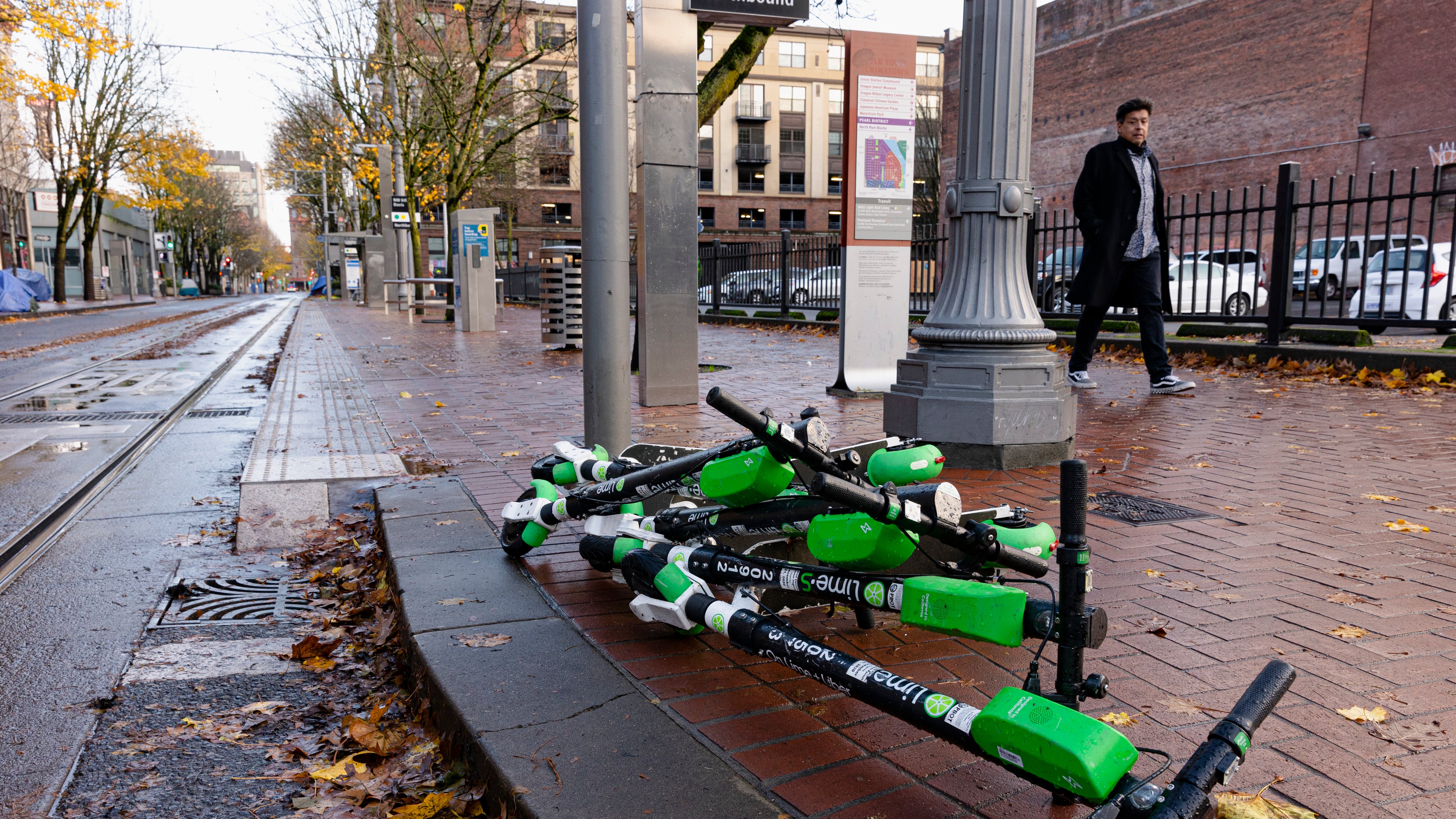 scooters piled on the sidewalk