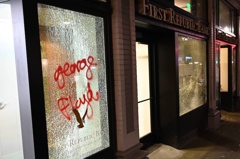 Windows of the First Republic Bank in downtown Portland are broken and spraypainted