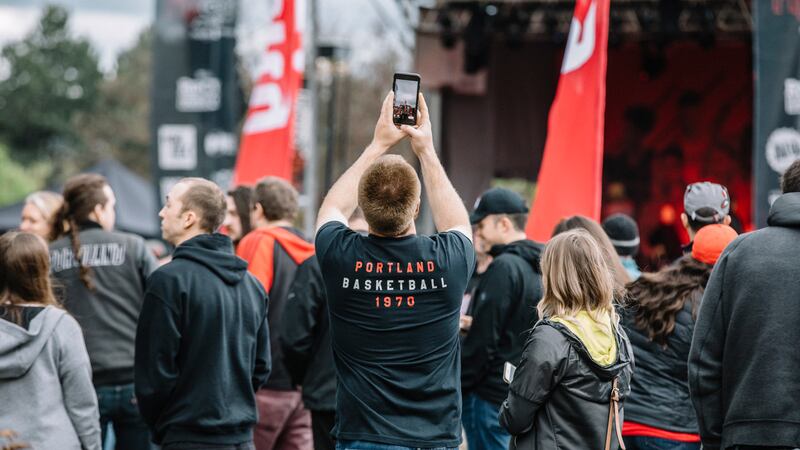 A Trail Blazers fan snaps a cellphone photo in the Rose Quarter during the 2019 playoffs.