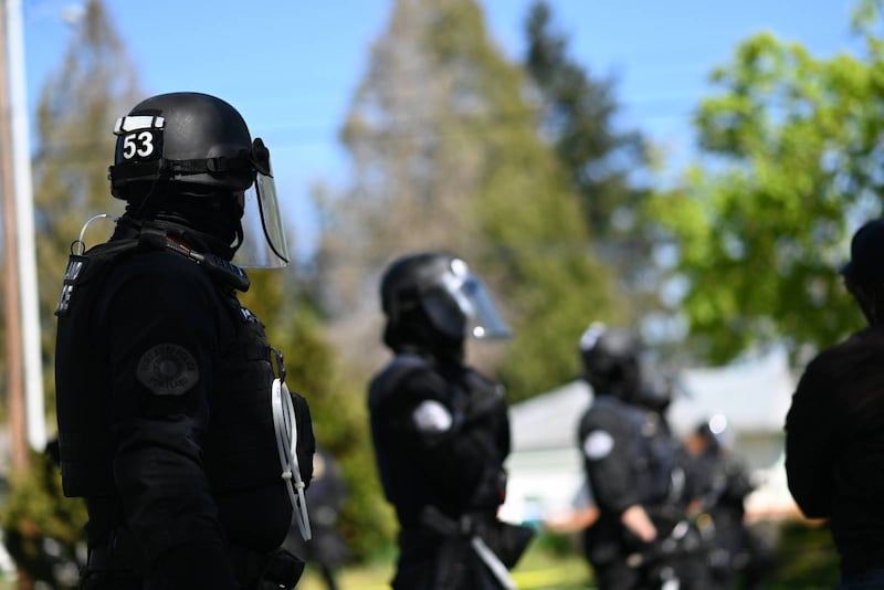 Police officers in riot gear.