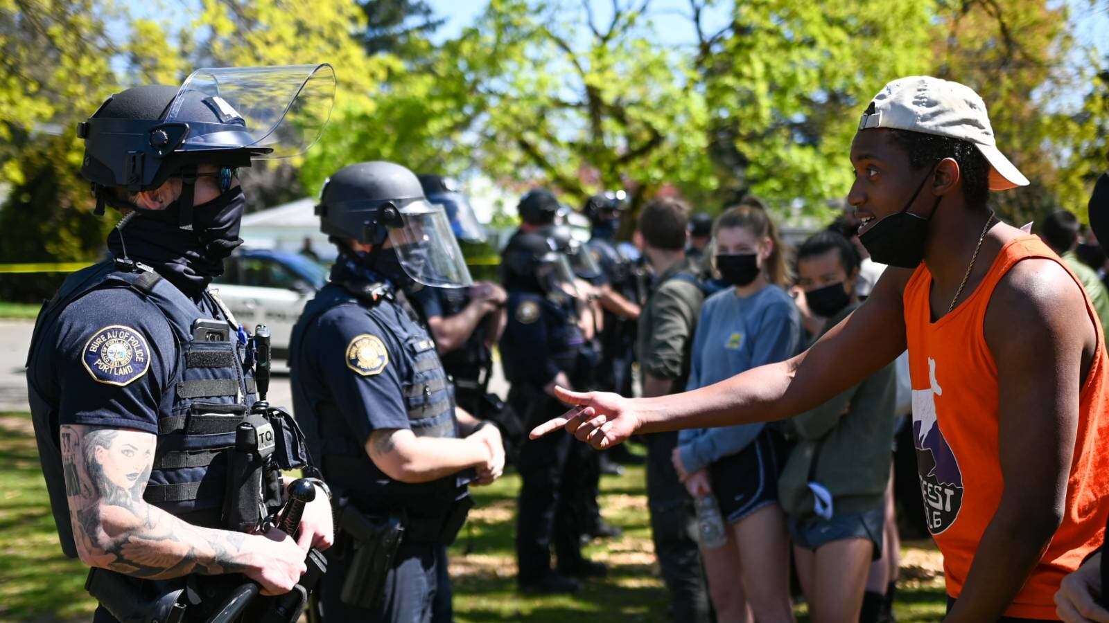 A man appeals to Portland police officers.