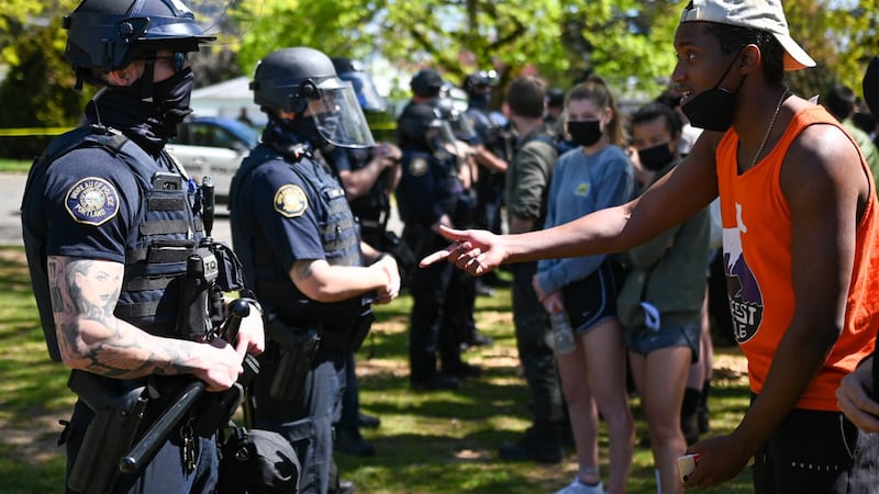 A man appeals to Portland police officers.