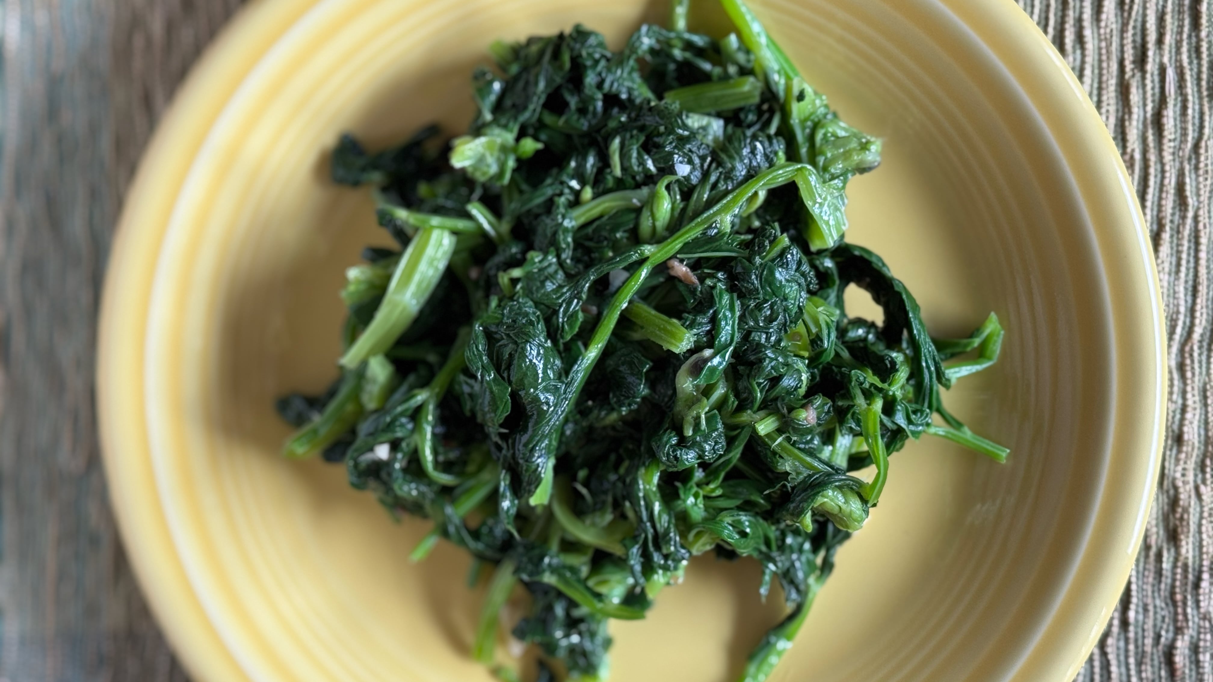 fava bean greens on a yellow plate