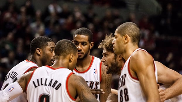 LaMarcus Aldridge and four teammates in a huddle.