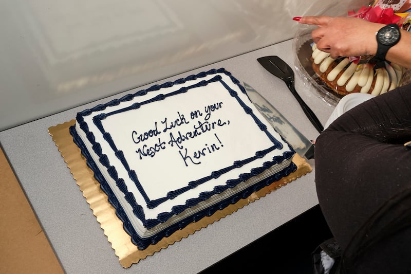 Mechanics enjoy a brief respite of cake at Kevin’s going-away party.