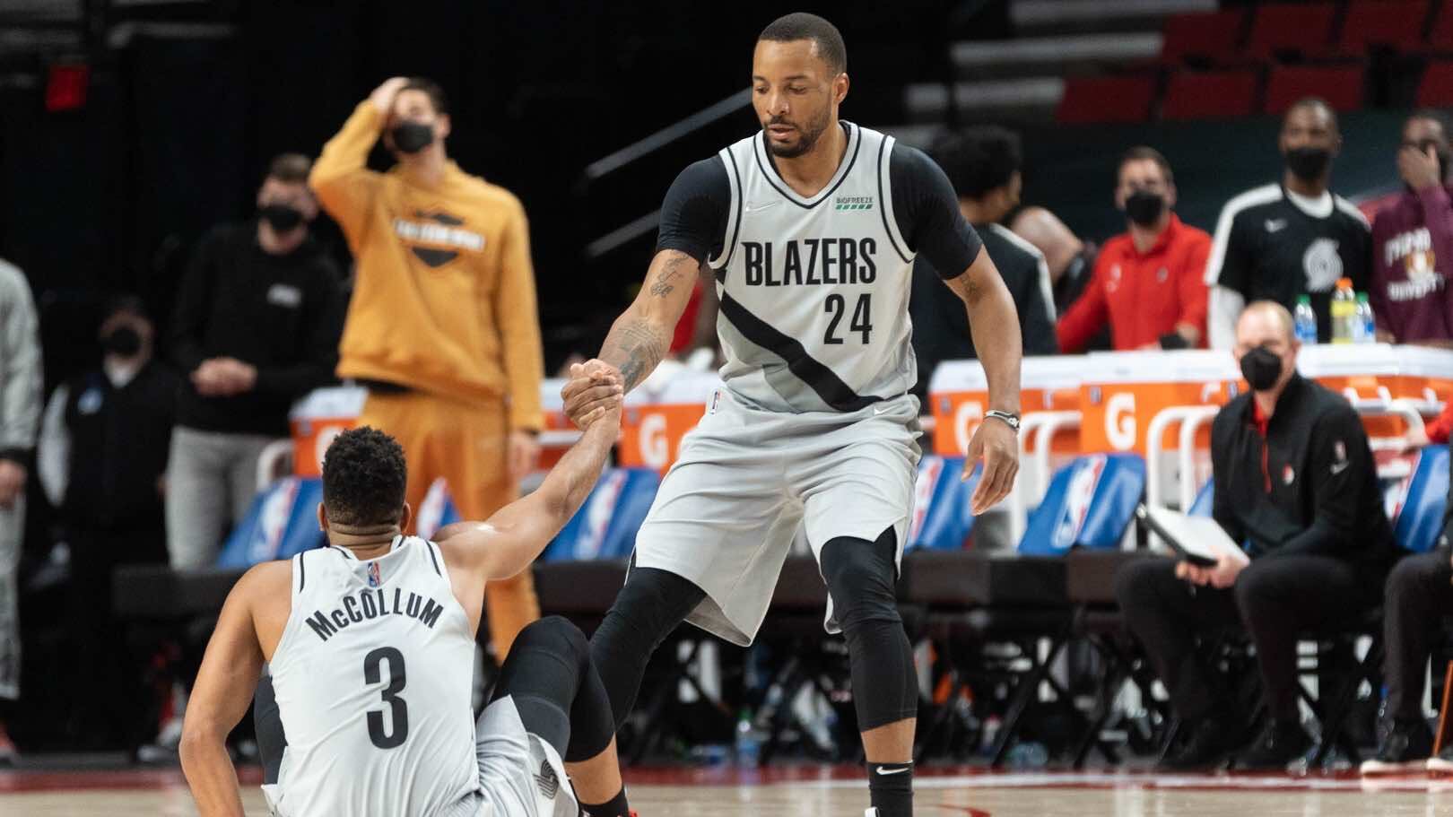 Norman Powell helps up CJ McCollum