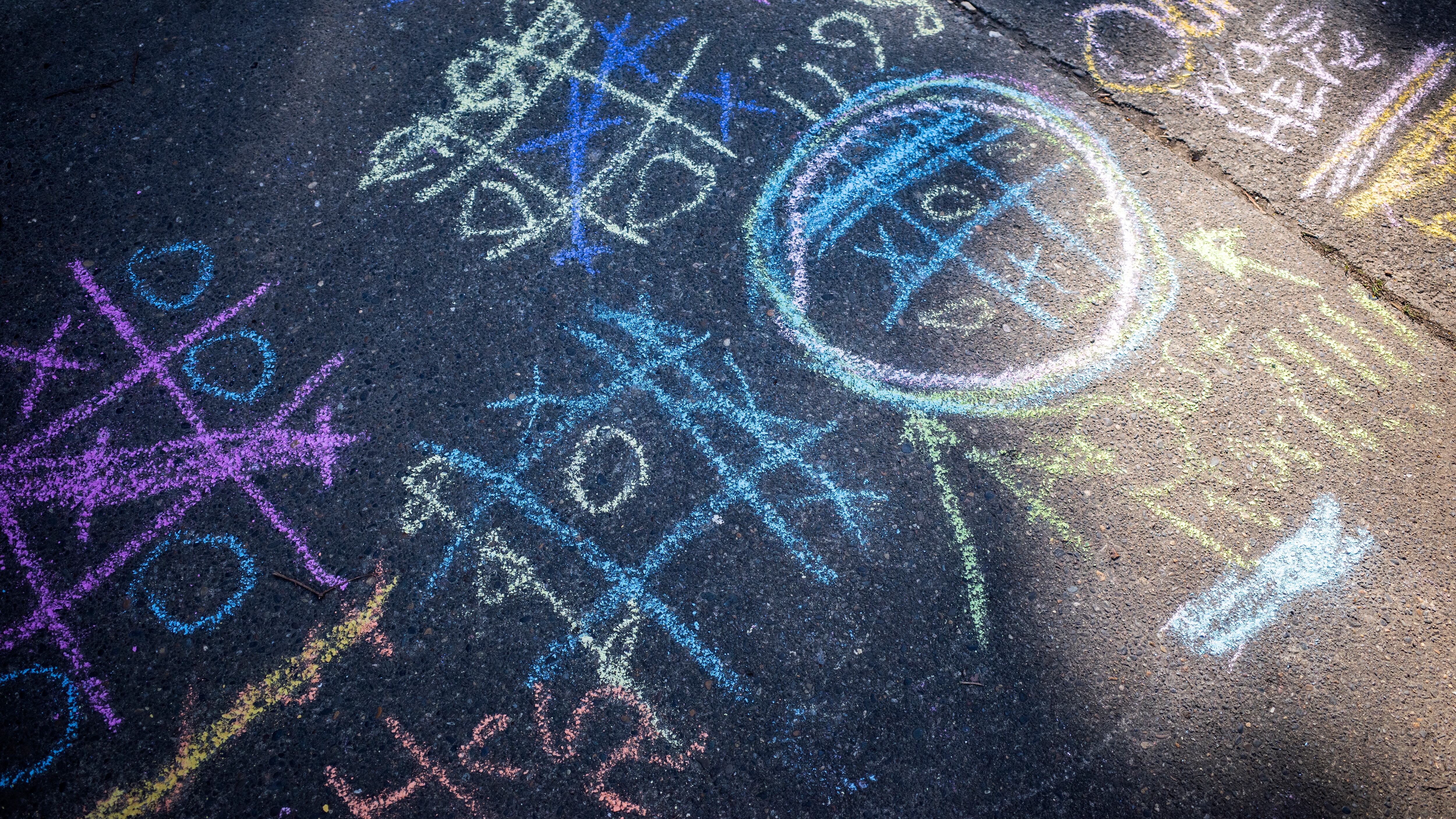 Chalk drawings on pavement.
